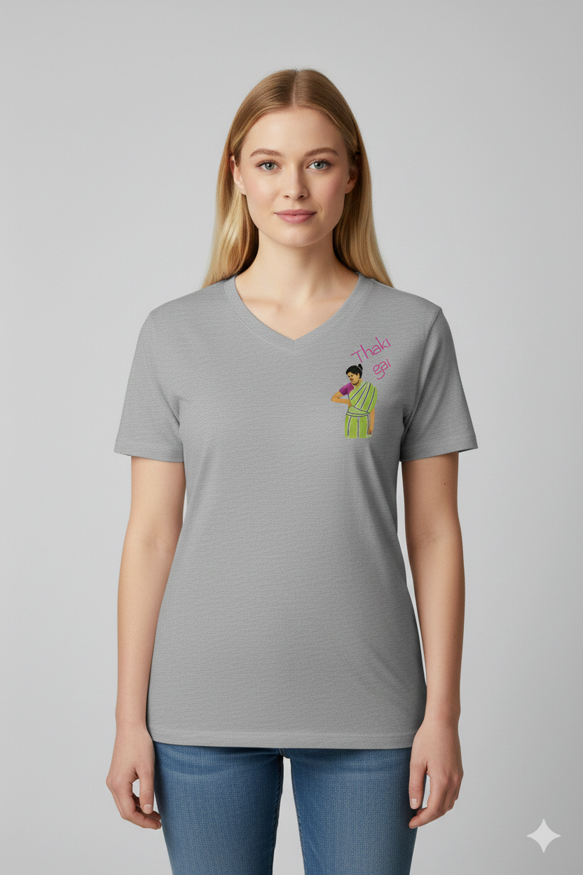 Woman wearing a grey t-shirt with a Thaki Gai graphic design on left chest