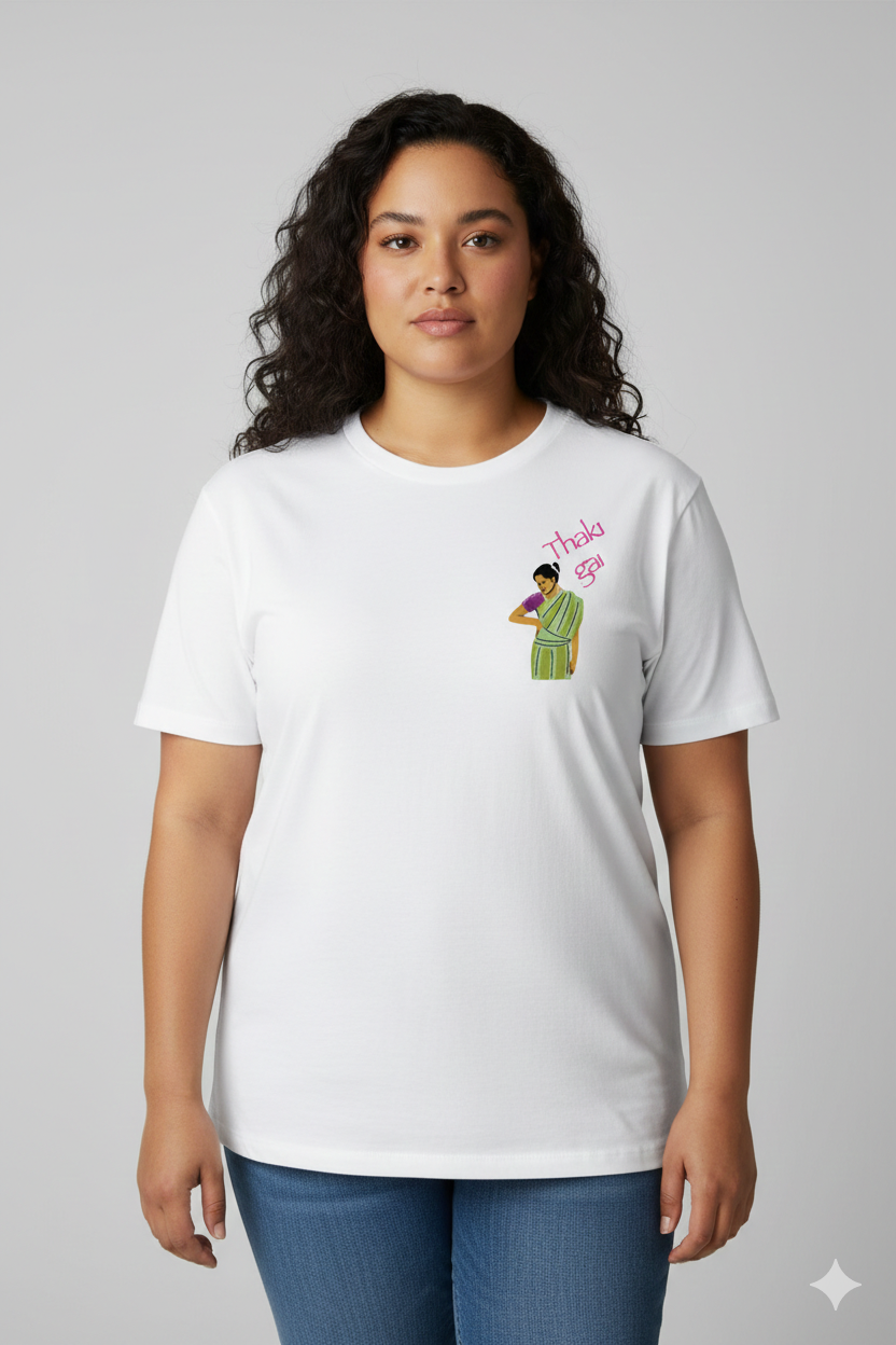 Woman wearing a white t-shirt with a Thaki Gai graphic design on left chest