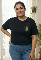 Woman wearing a black t-shirt with a Thaki Gai graphic design on left chest
