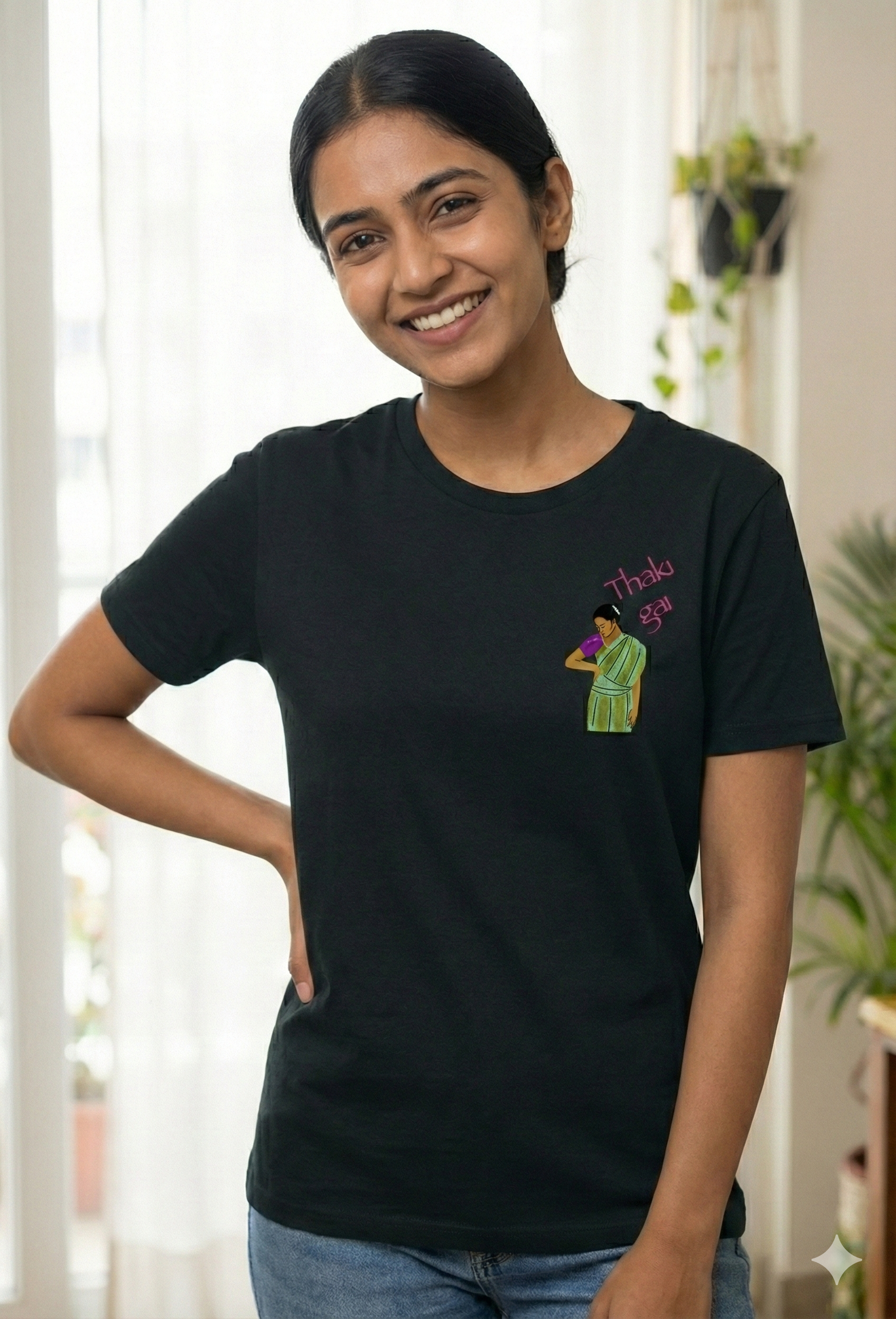 Woman wearing a black t-shirt with a Thaki Gai graphic design on left chest