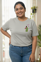 Woman wearing a grey t-shirt with a Thaki Gai graphic design on left chest