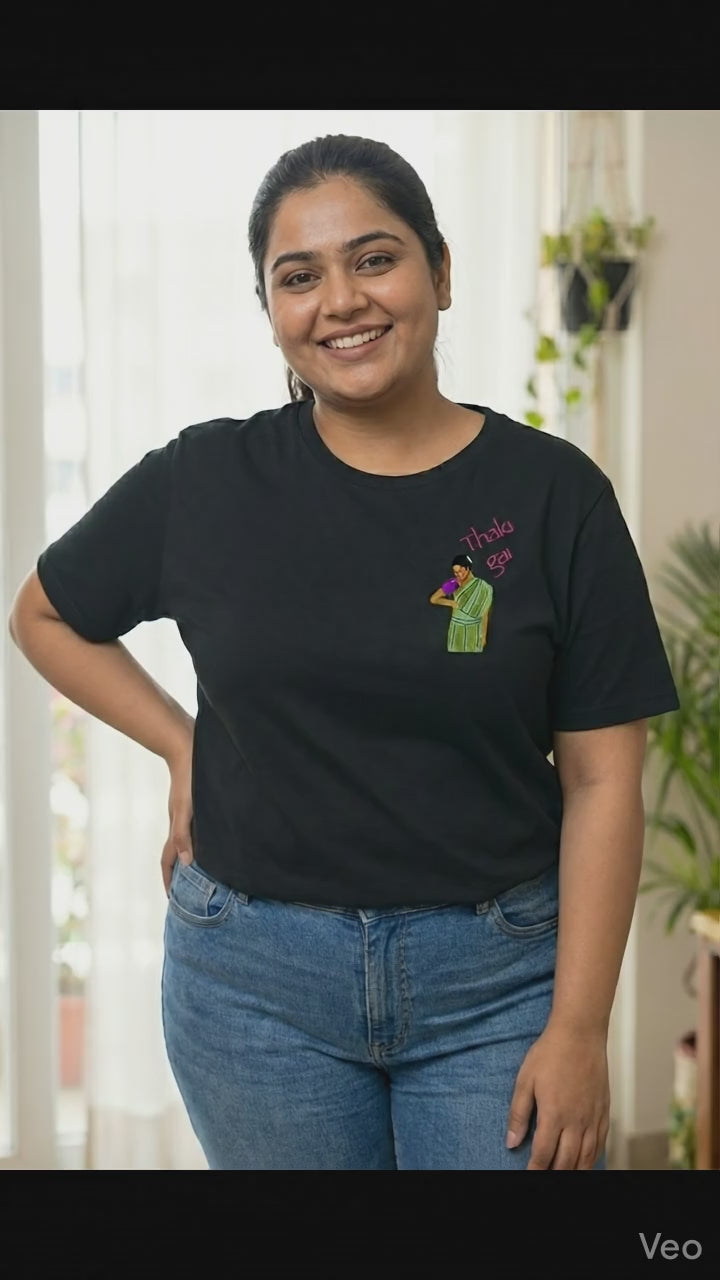 Woman wearing a black t-shirt with a Thaki Gai graphic design on left chest - video